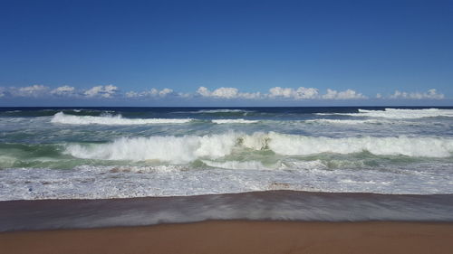 Scenic view of sea against blue sky