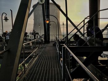 Railroad tracks in city against sky