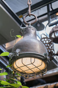 Low angle view of electric lamp hanging on ceiling