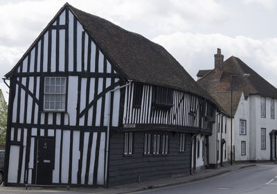 View of old building against cloudy sky in suffolk 