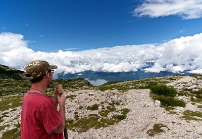 Man standing on mountain against sky