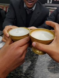 Midsection of man holding coffee cup