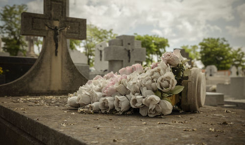 Plastic flowers on tomb in cemetery