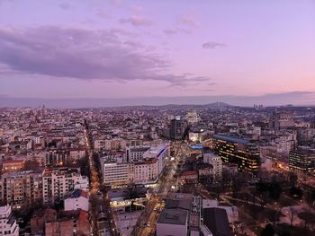 High angle view of illuminated buildings against sky during sunset