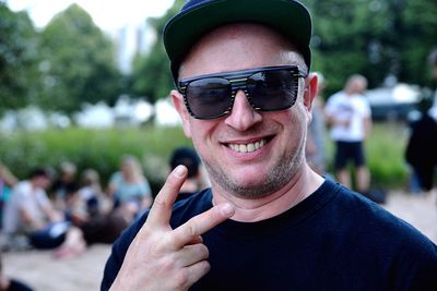 Portrait of smiling man showing peace sign