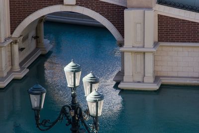 High angle view of old-fashioned street light by bride over canal