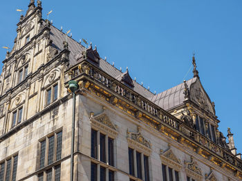 Low angle view of historic building against blue sky