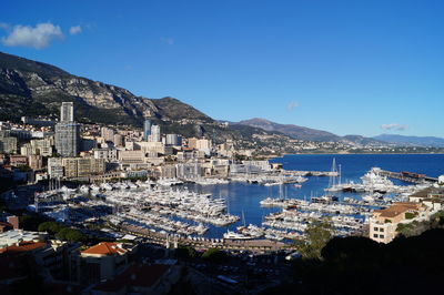 High angle view of townscape by sea against sky