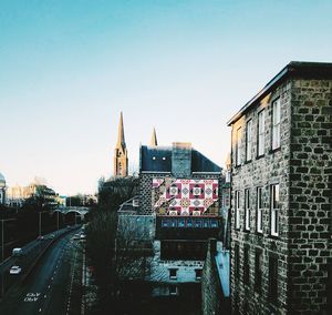 Buildings in city against clear sky