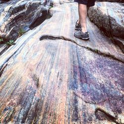 Low section of man standing on rock