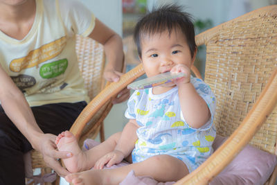 Full length of cute baby sitting outdoors