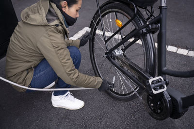 Woman blowing up tyres on her bike