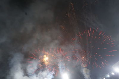 Low angle view of firework display at night