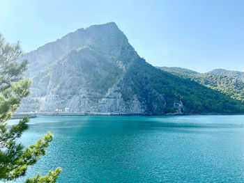 Scenic view of sea and mountains against sky