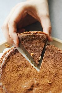 Close-up of hand holding cake