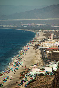 High angle view of sea and cityscape against sky