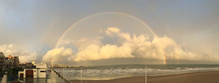 Panoramic view of rainbow over sea against sky