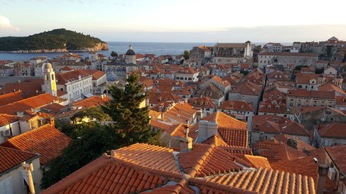 High angle view of townscape by sea against sky