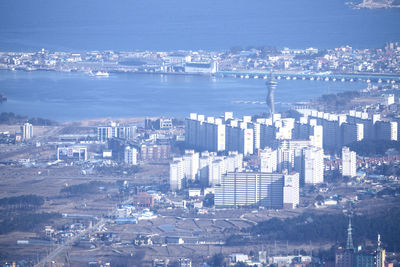 Aerial view of city by sea