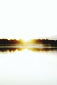 Scenic view of calm lake at sunset