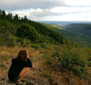 Man looking at mountain against sky