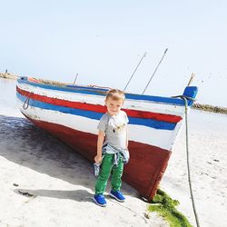 Full length of boy on beach against sky