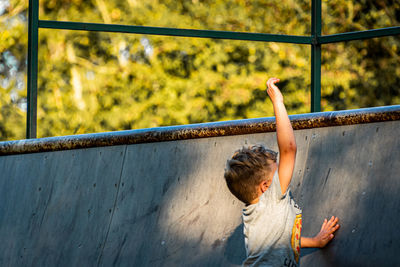 Boy playing at skateboard park