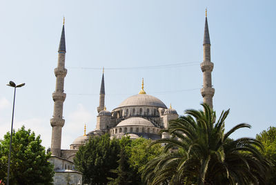Low angle view of sultan ahmed mosque against clear sky on sunny day