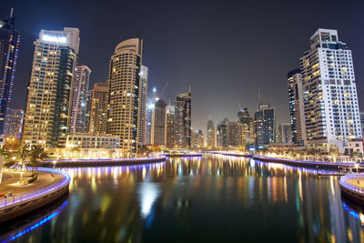 Illuminated buildings in city at night, dubai marina