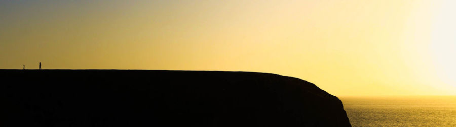 Scenic view of sea against clear sky during sunset