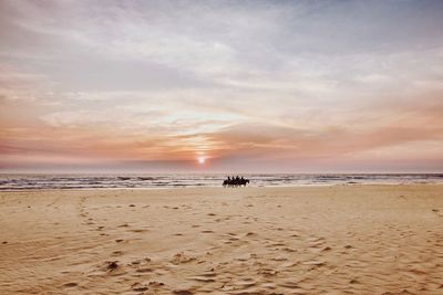 Scenic view of beach against sky during sunset