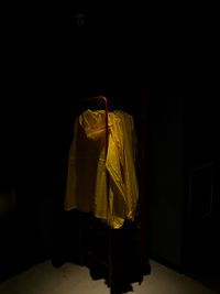 Close-up of clothes hanging against black background