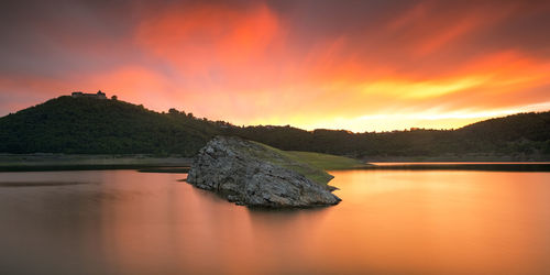 Scenic view of lake against sky during sunset