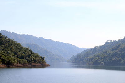 Scenic view of lake and mountains against clear sky