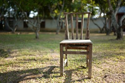 Empty chair on field in park