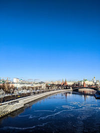 Bridge over river with buildings in background