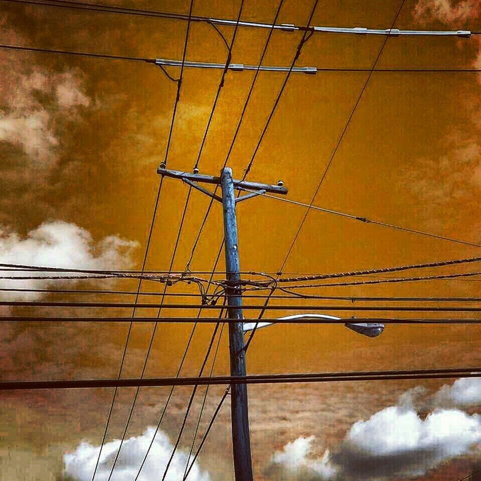 LOW ANGLE VIEW OF POWER LINES AGAINST CLOUDY SKY