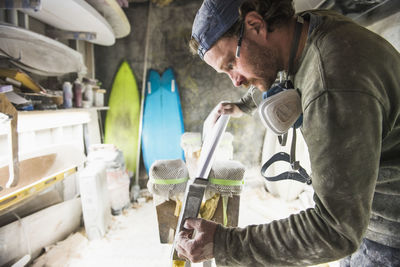 Surfboard shaper refining a new design
