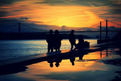 Bridge over river at sunset