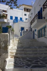 Footpath amidst buildings against sky