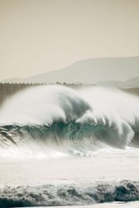 Waves on sea against sky