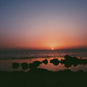 Scenic view of sea against clear sky during sunset