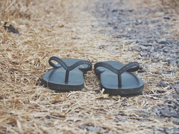 Close-up of shoes on sand