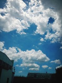 Low angle view of building against cloudy sky