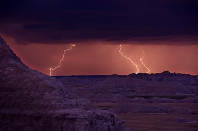 Panoramic view of lightning over mountain