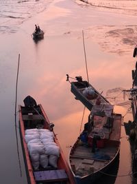 Boats sailing in sea against sky during sunset