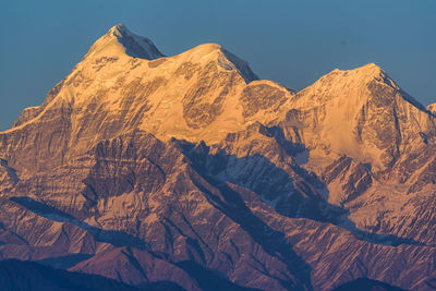 Scenic view of snowcapped mountains against clear sky