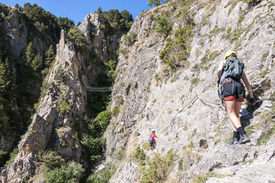 View of people rock climbing