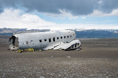 Abandoned military aircraft wreck at black sand beach in solheimasandur