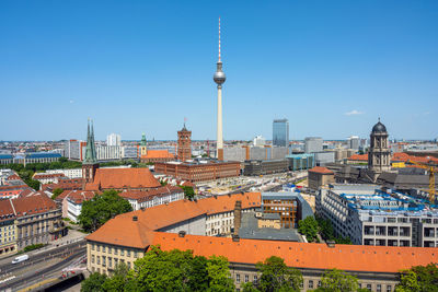 Cityscape against clear blue sky